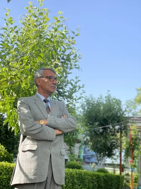 A staff member standing in the school garden